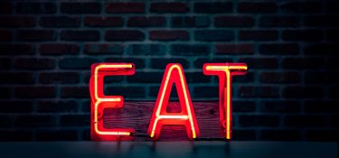 Glowing red EAT sign